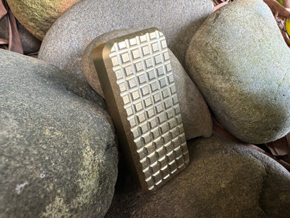 Brass RiveryMFG Zero Knife grenade handle pattern on stones