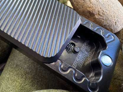 Black RiveryMFG Zero-6061 Aluminum with lanyard hole utility knife with lid open.