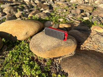 RiveryMFG Zero custom combination utility knife with grenade black lid and red base.