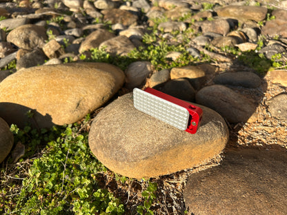 RiveryMFG Zero custom combination utility knife with grenade gray lid and red base.