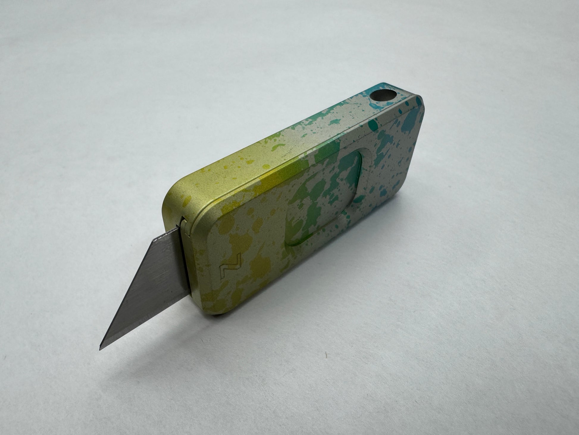 Multicolor Sunkissed RiveryMFG Zero CadLab Collaboration utility knife with operator pattern