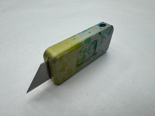 Multicolor Sunkissed RiveryMFG Zero CadLab Collaboration utility knife with operator pattern